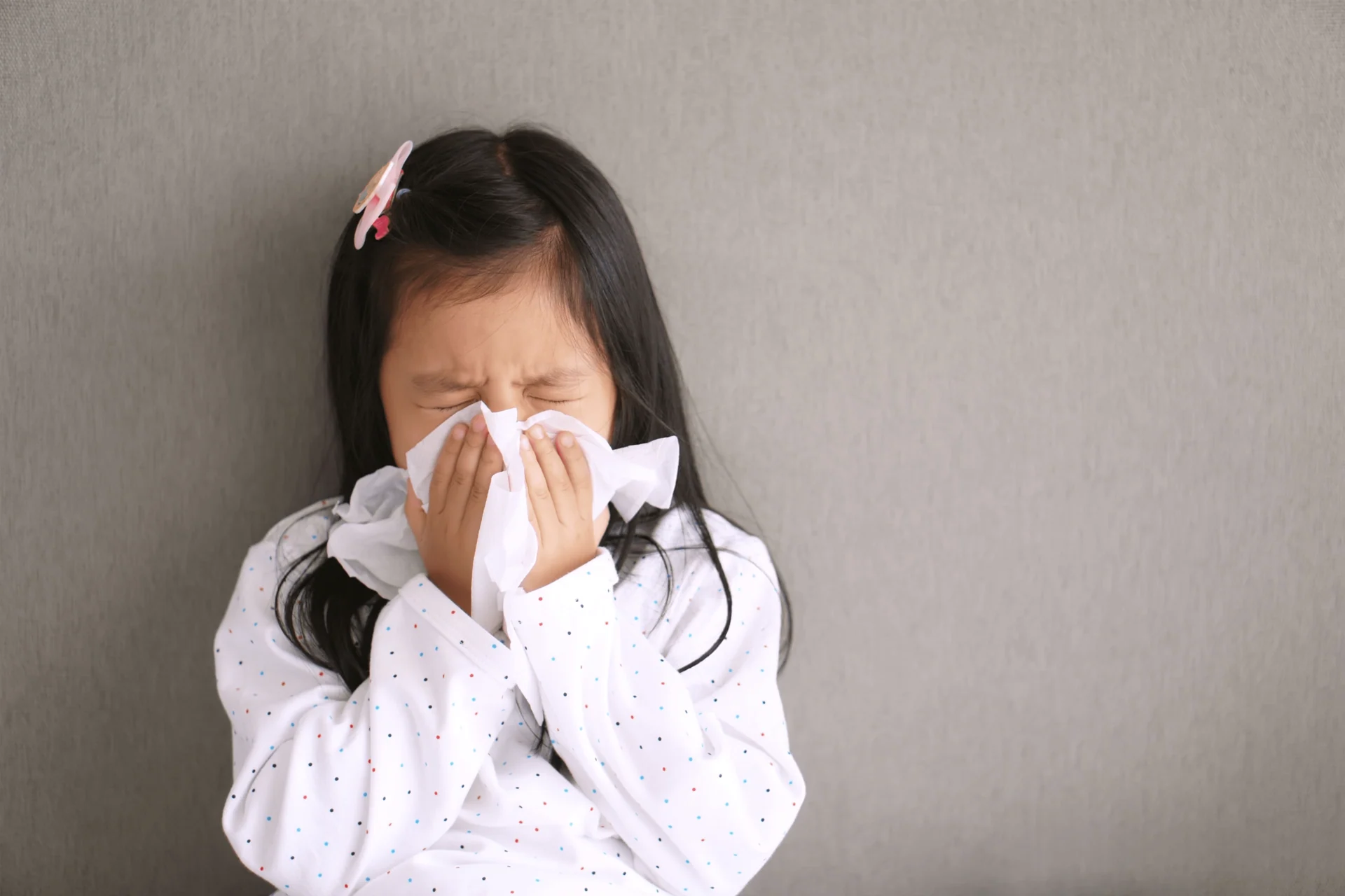 girl blowing her nose