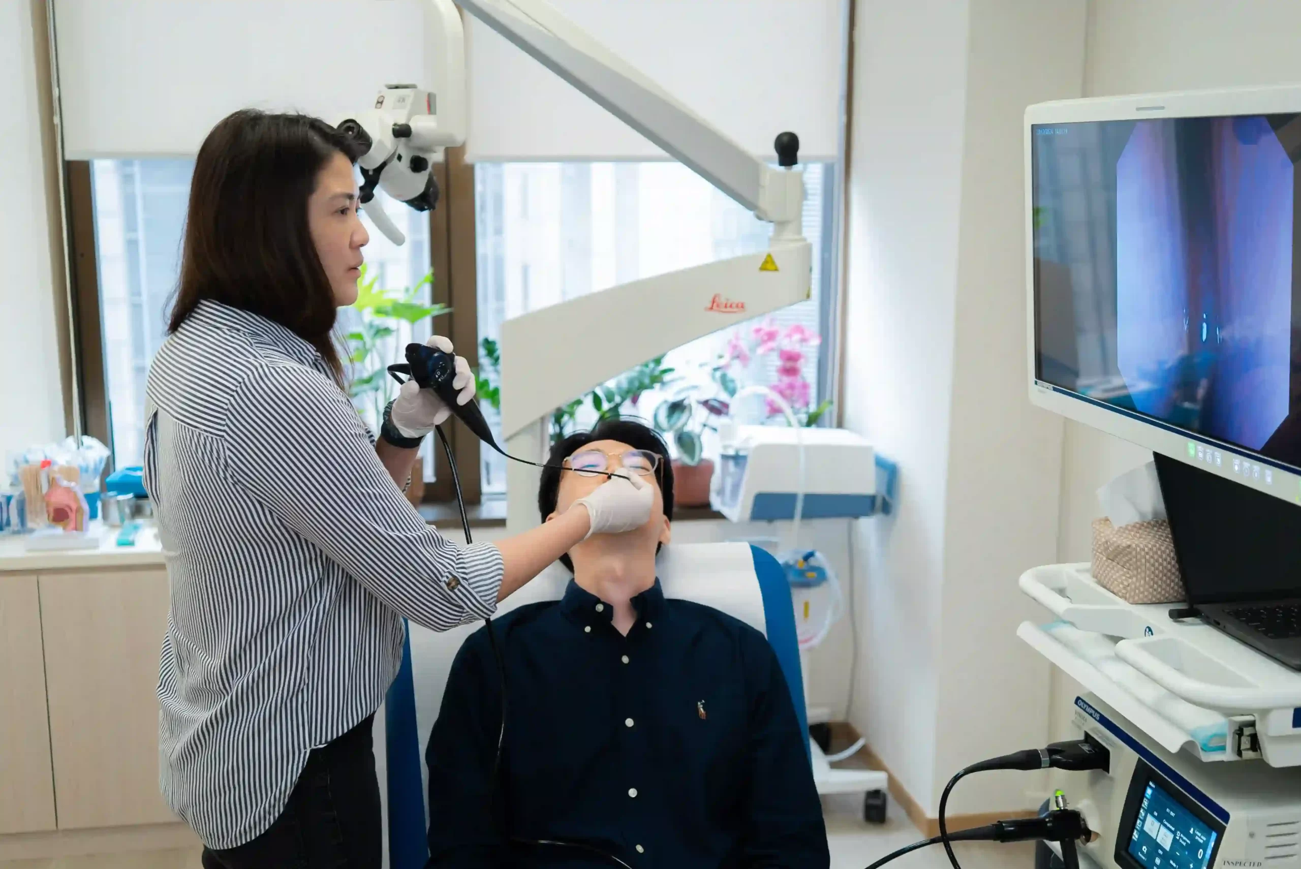 Dr Ker Liang uses a naso-endoscope to examine the patient's nasal passages.